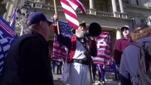 Donald Trump supporters rally outside Michigan state house in Lansing and argue with opponents as Republican loses to Joe Biden