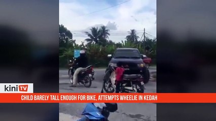 Child barely tall enough for bike, attempts wheelie in Kedah, caught by cops