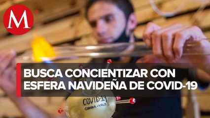 Artesano crea esfera en forma de coronavirus en Chignahuapan