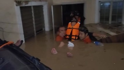 Woman rescued amid neck-deep floodwaters