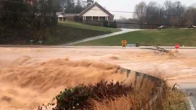 Rushing floodwaters overwhelmed washed-out road