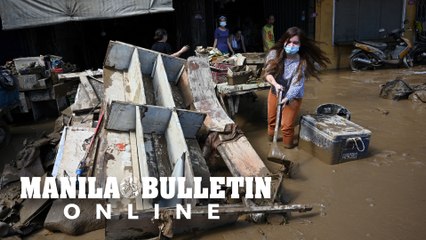 People return into their mud-covered homes after being hit by Typhoon 'Ulysses'