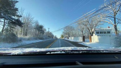 Car With Snowy Windshield on Wrong Side of Road