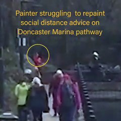 Painter struggles to paint social distancing sign in Doncaster