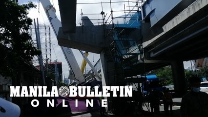 A metal crane carrying a part of Skyway falls along East Service Road