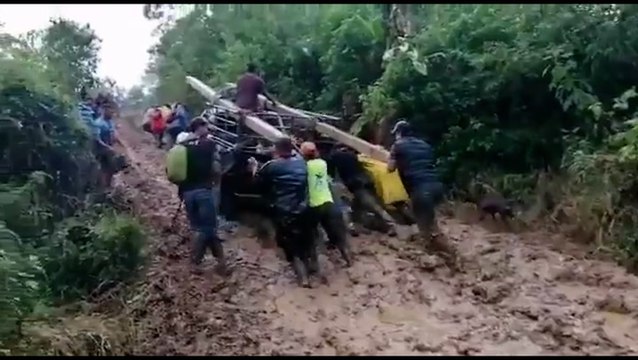 Honduran community members push truck filled with supplies to get repairs going after Iota