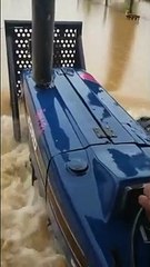 Tractor traverses deluge of water Penal Rock Road