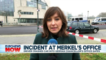 Car daubed with anti-globalisation message crashes into gate of Angela Merkel's Berlin office