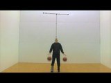 Man Dribbles Two Basketballs While Balancing Two Crutches On Chin