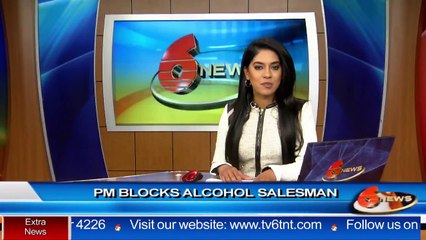 Prime Minister Dr. Keith Rowley blocks alcohol salesman