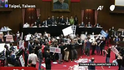 Pig guts fly in Taiwan parliament protest
