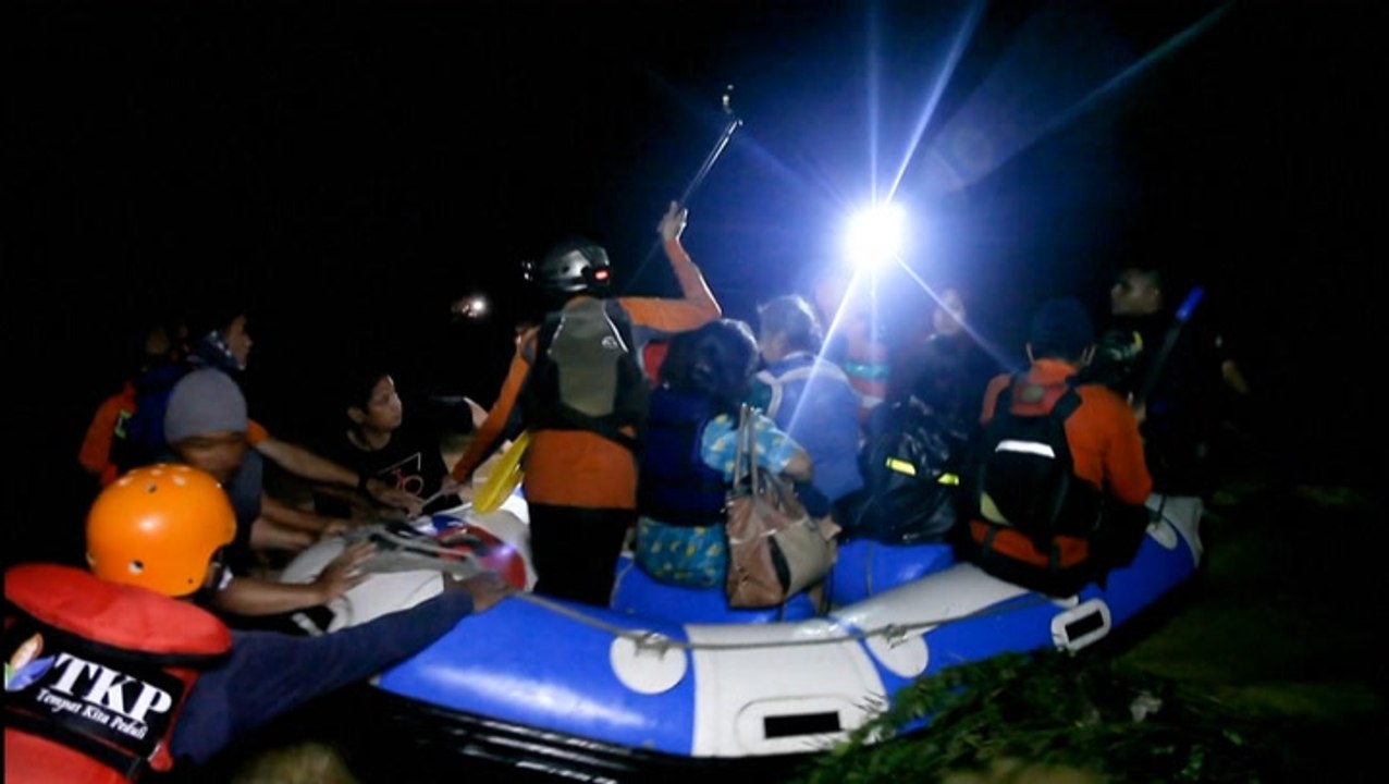 Rescuers scramble to save people from flooding in Indonesia