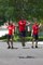 Three Guys Perform Coordinated Jump Rope Tricks