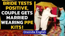 Watch: Couple, priest perform rituals in PPE kit after bride tests COVID+ in Rajasthan|Oneindia News