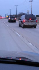 Car Drives Along With Gas Pump Handle Hanging From Car