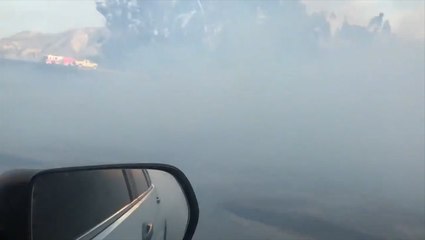 Driver passes through heavy smoke as Cornell Fire burns