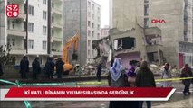 Siirt'te deprem sonrası yan yatan 2 katlı binanın yıkımı sırasında gerginlik