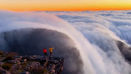 Clouds cascade down mountainside