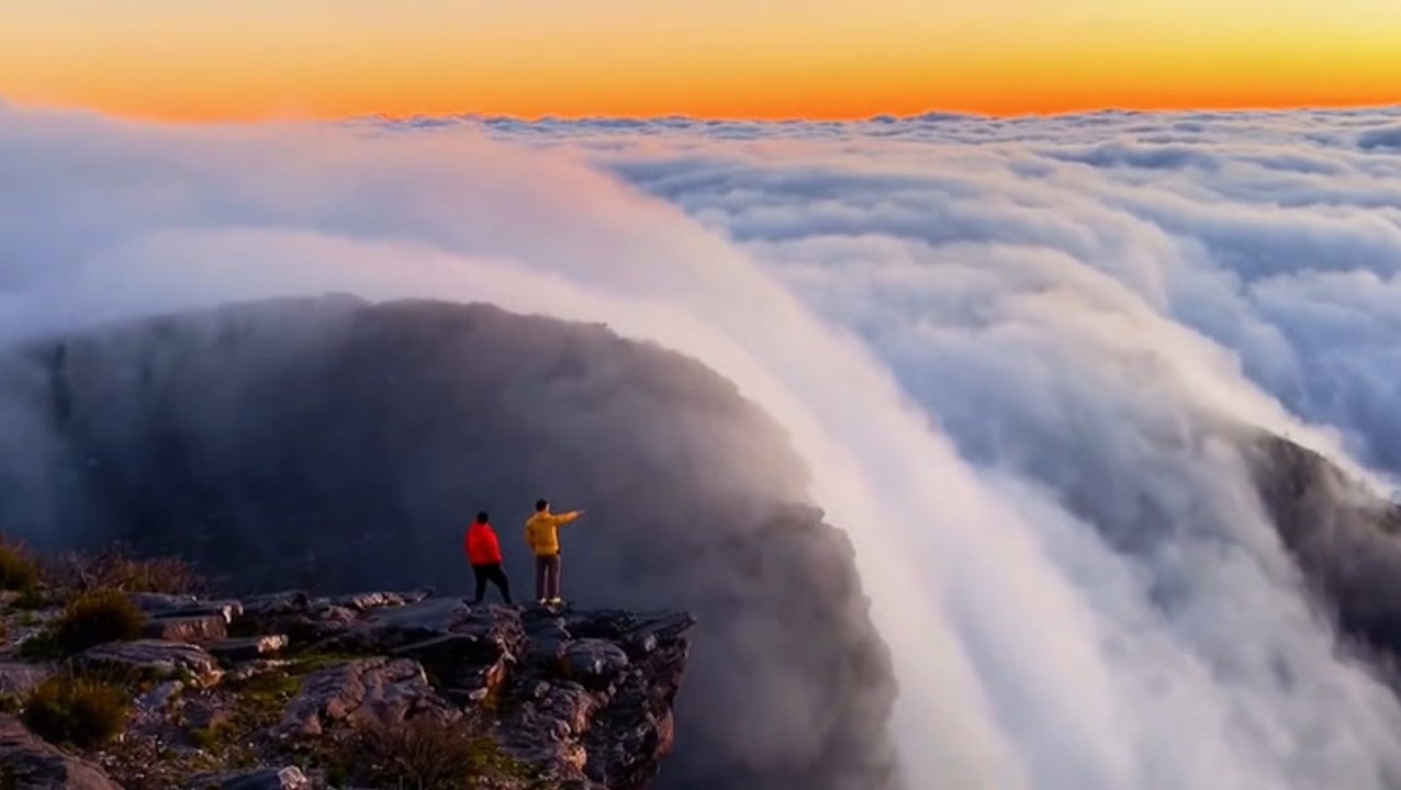 Clouds cascade down mountainside