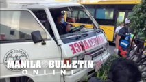 Rescuers extricate an ambulance driver after collision with a bus