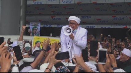 Indonesian Muslim leader turns himself in over COVID rule breach