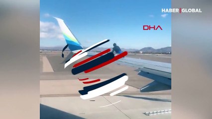 Kalkışa hazırlanan uçağın kanadına çıktı