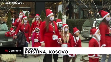 Santas gather in Pristina's main square to raise money for those hit by coronavirus pandemic