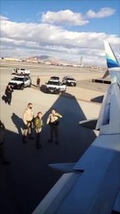 Man Climbs on Plane Wing While on Airport Runway