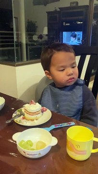 Young Boy Struggles to Stay Awake at Dinner