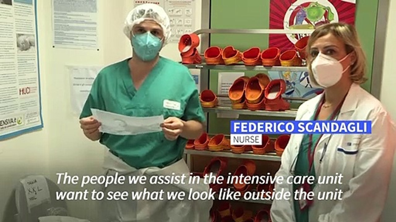 Italian healthcare workers display face on protective gear to reassure patients