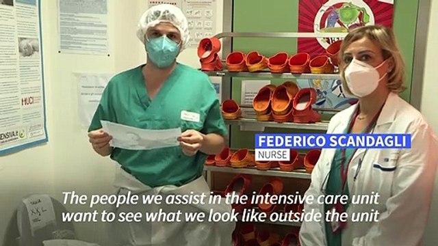 Italian healthcare workers display face on protective gear to reassure patients
