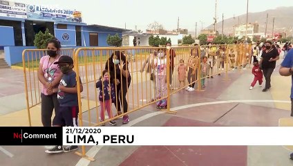 Santa meets children in Peru through a plastic bubble amid COVID measures