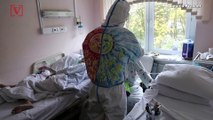 Hospital Volunteer Draws and Paints on Protective Suit To Bring Smiles To COVID Patients