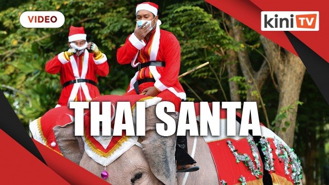Santa rides elephants to Thai town, bearing gifts of face masks