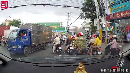 Truck Stops on Top of Motorcycle in Busy Intersection