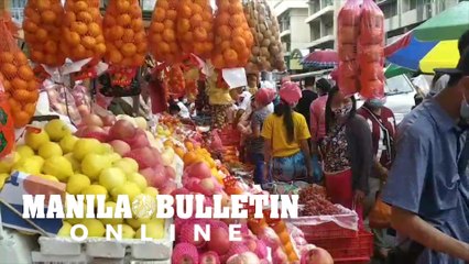Residents in Davao City buying round fruits ahead of the New Year's eve celebration