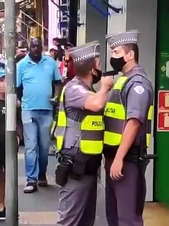 Un policier pointe son arme sur un collègue