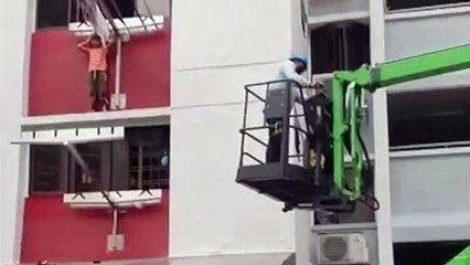 Caught on cam_ child hangs by window ledge as he waits for rescue