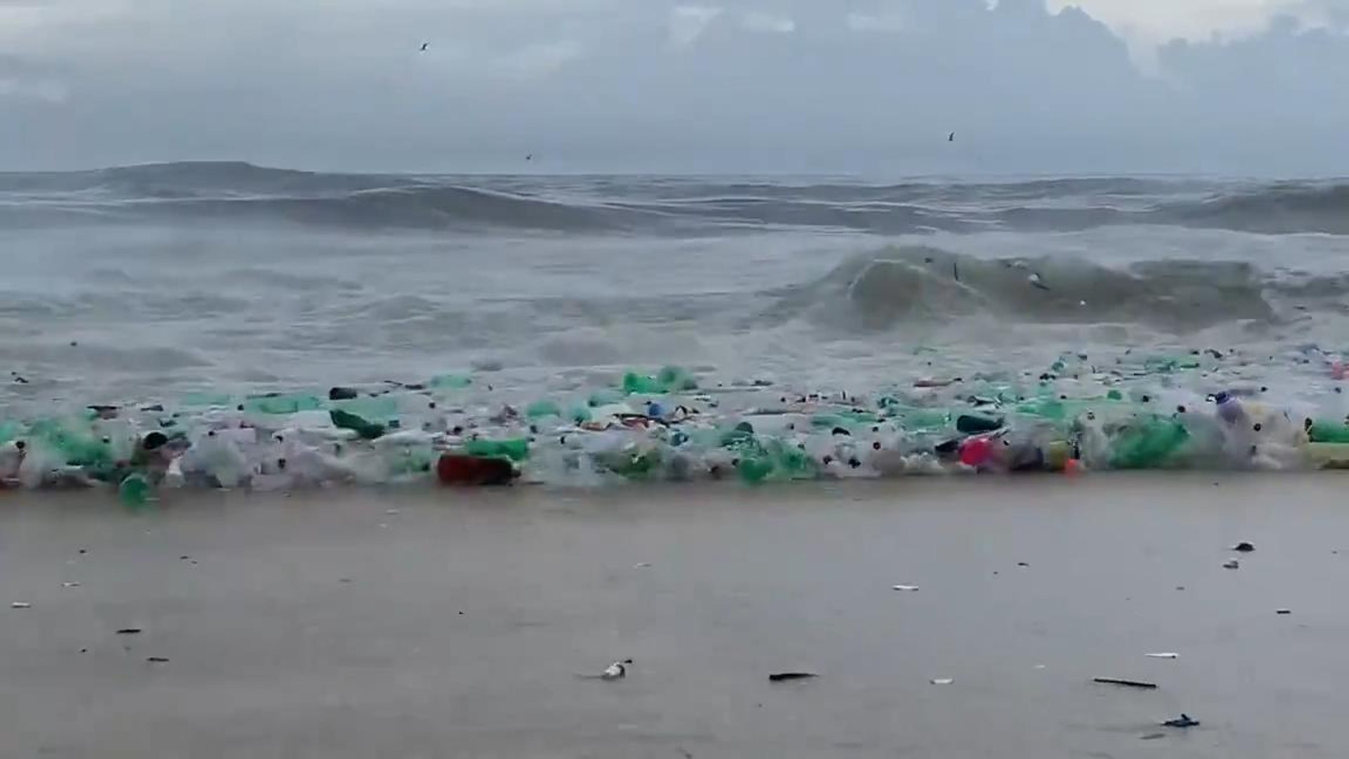 ⁣Sea Waves Bring Plastic Waste Materials Into Shore