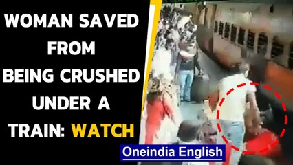 Download Video: RPF personnel save woman from being run over by a train, mishap averted: watch| Oneindia News