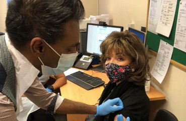 Dame Joan Collins receives COVID vaccine