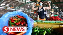 Fitness trainer keeps his chin up, returns to work at wet market due to MCO 2.0