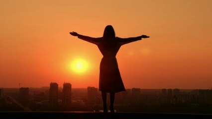 Girl Spreading Her Arms in Front of the Setting Sun