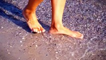 Girl Enjoying the Beach Water with Her Bare Legs