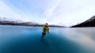 Man Ice Skates On A Frozen Lake During Breathtaking Trip