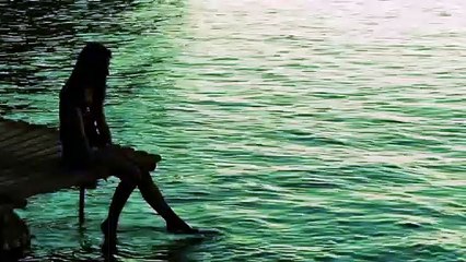 Girl Enjoying the Beach Water While Dangling Her Legs