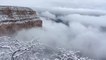 Clouds fill a snow-dusted Grand Canyon