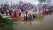 Chhat Puja on the banks of the Yamuna river_ women in colourful sarees dip into cold polluted river