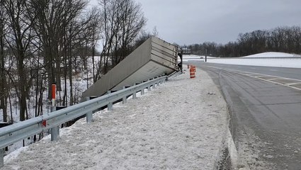 Tractor trailer crashes off of highway in treacherous road conditions