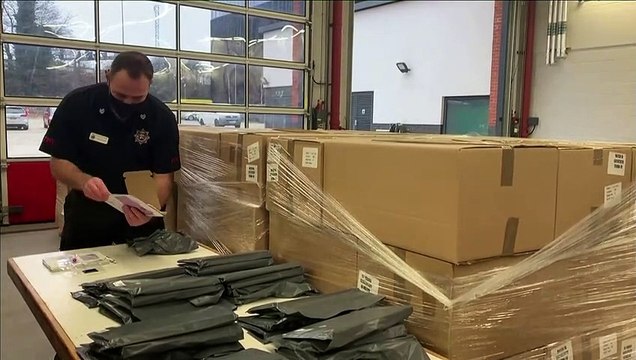 Firefighters in Woking prepare home testing kits for areas affected by South African variant